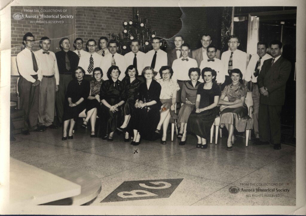 Barber Greene employees in lobby December 1955. In center front is Jackie Shanahan who was AHS Office Manager for 20 years until 2013. (Aurora Historical Society Photo)